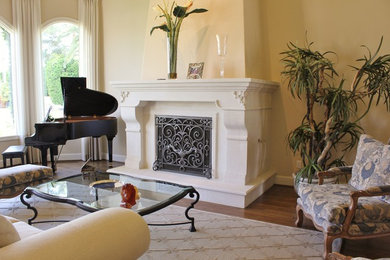 Living room - mid-sized mediterranean formal and enclosed dark wood floor living room idea in Phoenix with beige walls, a standard fireplace, a stone fireplace and no tv