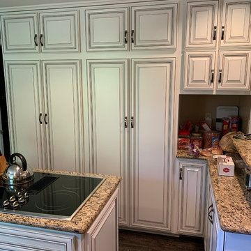 refaced cabinets------antique white w black glaze and new flooring