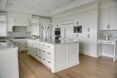 Design ideas for a contemporary kitchen in Vancouver with flat-panel cabinets and with island.