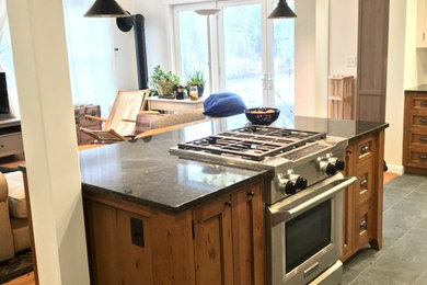 Inspiration for a timeless ceramic tile kitchen remodel in Boston with a farmhouse sink, granite countertops and stainless steel appliances