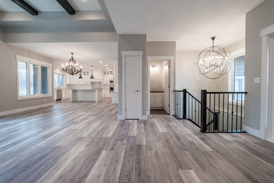 Example of a large minimalist formal and open concept vinyl floor and multicolored floor living room design in Edmonton with a standard fireplace and a brick fireplace