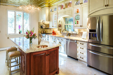 Enclosed kitchen - large victorian galley beige floor and porcelain tile enclosed kitchen idea in Cedar Rapids with an undermount sink, white cabinets, stone slab backsplash, stainless steel appliances, an island, granite countertops, raised-panel cabinets and multicolored backsplash