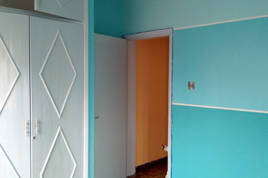 Example of a small trendy guest bedroom design in Other with blue walls
