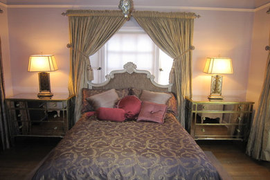 Example of a mid-sized eclectic master medium tone wood floor bedroom design in Los Angeles with purple walls