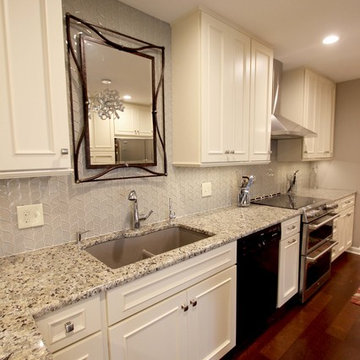 Medallion Painted White Chocolate Kitchen Cabinets with Petal Mosaic Backsplash
