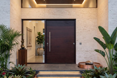 Example of a large minimalist entryway design in Miami with a dark wood front door