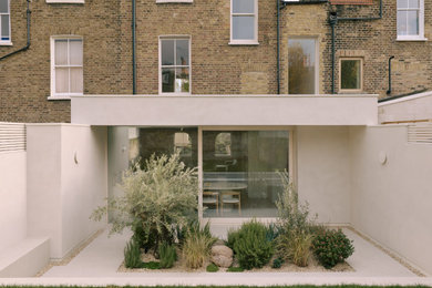 Inspiration for a large and beige scandi concrete and rear house exterior in London with four floors.