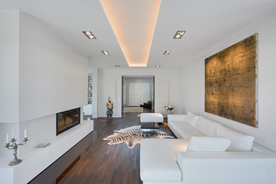 Photo of a large contemporary living room in Berlin with white walls and a ribbon fireplace.