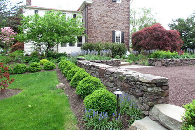 This is an example of a large country garden in New York with natural stone pavers.