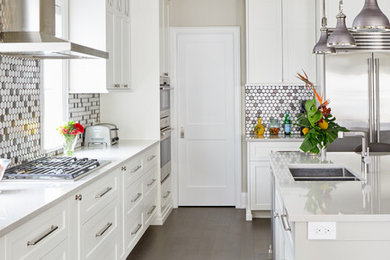 Large trendy l-shaped medium tone wood floor and gray floor open concept kitchen photo in Toronto with an undermount sink, shaker cabinets, white cabinets, quartz countertops, multicolored backsplash, mosaic tile backsplash, stainless steel appliances, an island and gray countertops