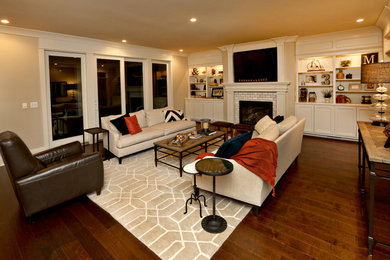 Large transitional formal and enclosed dark wood floor living room photo in Louisville with beige walls, a standard fireplace, a plaster fireplace and a wall-mounted tv