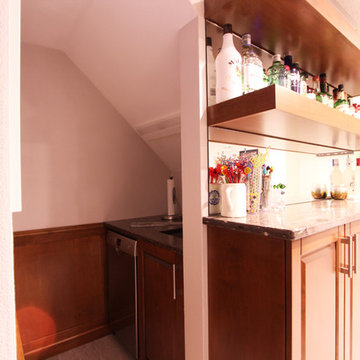 Bar Sink and Small Refrigerator Tucked Under Stairs