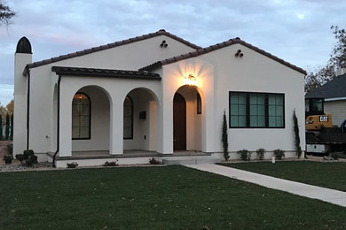 Mid-sized tuscan white one-story stucco exterior home photo in Salt Lake City with a tile roof