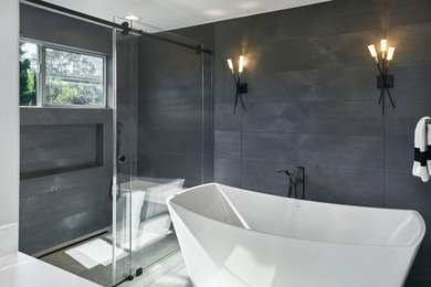 Example of a large trendy master gray tile and porcelain tile porcelain tile, gray floor and double-sink bathroom design in San Francisco with flat-panel cabinets, dark wood cabinets, a two-piece toilet, gray walls, an undermount sink, quartz countertops, a hinged shower door, white countertops, a niche and a freestanding vanity