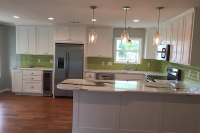 Kitchen - modern kitchen idea in Austin with an undermount sink, shaker cabinets, white cabinets, marble countertops, green backsplash, subway tile backsplash, stainless steel appliances and white countertops