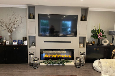 Design ideas for a contemporary living room in London with grey walls and a built-in media unit.