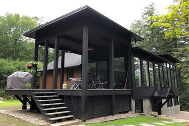 Large trendy two-story mixed siding house exterior photo in Montreal with a mixed material roof