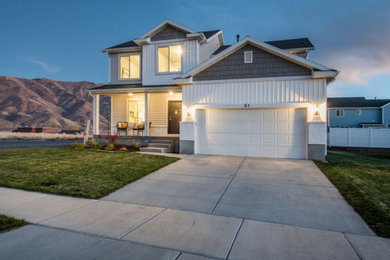 Inspiration for a large craftsman white two-story stucco house exterior remodel in Salt Lake City