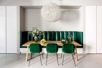 Inspiration for a mid-sized modern dining room in London with grey walls and grey floor.