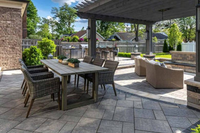 Patio - mid-sized backyard brick patio idea in Austin