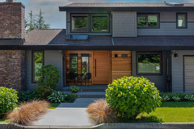 Large elegant gray two-story wood house exterior photo in Seattle