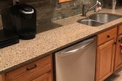 Example of a mid-sized classic l-shaped ceramic tile and beige floor eat-in kitchen design in Chicago with a double-bowl sink, raised-panel cabinets, medium tone wood cabinets, quartz countertops, gray backsplash, ceramic backsplash and stainless steel appliances