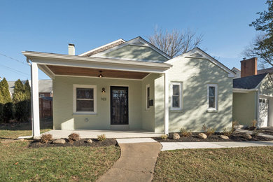 Mid-sized transitional green two-story brick exterior home photo in Wilmington with a shingle roof