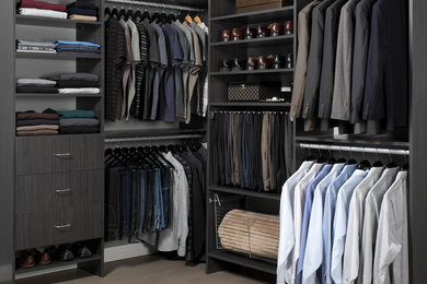 Mid-sized modern men's walk-in wardrobe in Los Angeles with flat-panel cabinets and grey cabinets.