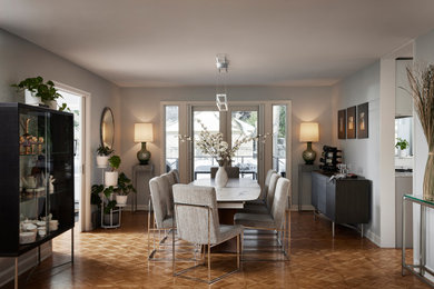 Large trendy medium tone wood floor and brown floor dining room photo in Minneapolis with gray walls