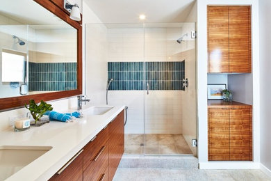 Example of a large minimalist master blue tile, white tile and glass tile porcelain tile and gray floor alcove shower design in Dallas with flat-panel cabinets, medium tone wood cabinets, white walls, an undermount sink and quartz countertops