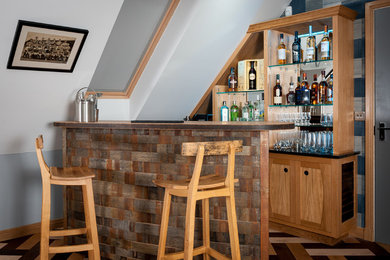 Design ideas for a medium sized eclectic galley home bar in Other with recessed-panel cabinets, medium wood cabinets, wood worktops, mirror splashback and medium hardwood flooring.