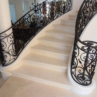 Photo of a large mediterranean tiled curved staircase in Orange County with tiled risers.