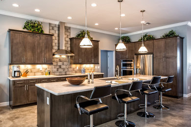 Inspiration for a large transitional l-shaped concrete floor and brown floor open concept kitchen remodel in Phoenix with an undermount sink, shaker cabinets, gray cabinets, granite countertops, gray backsplash, cement tile backsplash, stainless steel appliances and an island