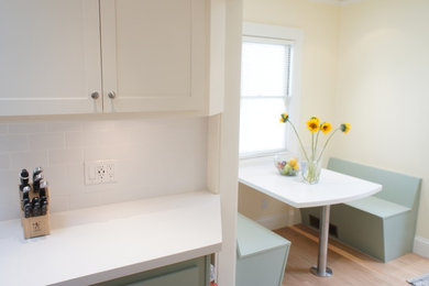 Cottage light wood floor enclosed kitchen photo in San Francisco with an undermount sink, shaker cabinets, green cabinets, quartz countertops, white backsplash, ceramic backsplash and stainless steel appliances