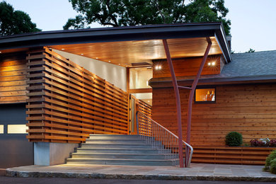 Example of a large trendy brown two-story wood gable roof design in New York