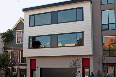 Photo of a mid-sized contemporary three-storey beige exterior in San Francisco with wood siding and a flat roof.