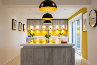 Design ideas for a medium sized modern single-wall kitchen/diner in Other with a single-bowl sink, flat-panel cabinets, an island, white floors, white worktops and feature lighting.