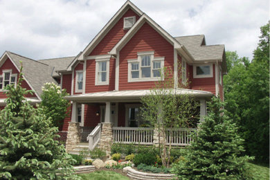 This is an example of a large arts and crafts three-storey red exterior in Columbus with mixed siding.