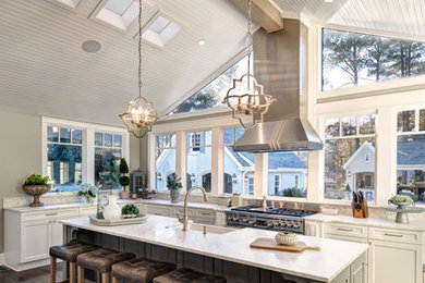 Kitchen - traditional l-shaped medium tone wood floor and brown floor kitchen idea in Other with a farmhouse sink, shaker cabinets, marble countertops, white backsplash, ceramic backsplash, stainless steel appliances and an island