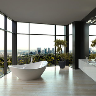 Design ideas for a contemporary bathroom in Adelaide with flat-panel cabinets, white cabinets, a freestanding tub, black walls, an integrated sink and beige floor.
