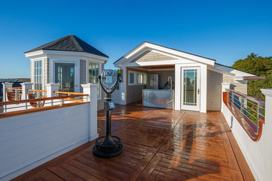 Large traditional rooftop deck in Portland Maine with an outdoor kitchen and no cover.