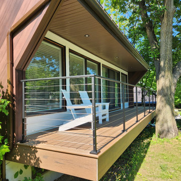 Deck with black metal post cable railing in Quebec, Canada