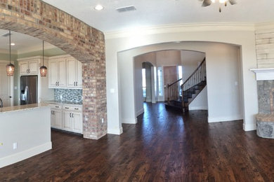 Inspiration for a large timeless open concept medium tone wood floor family room remodel in Dallas with a corner fireplace and a stone fireplace