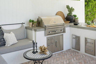 Inspiration for a mid-sized coastal backyard brick patio remodel in Los Angeles