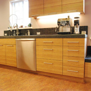 Design ideas for a mid-sized contemporary galley kitchen pantry in San Francisco with a single-bowl sink, flat-panel cabinets, medium wood cabinets, solid surface benchtops, grey splashback, stainless steel appliances, cork floors and stone slab splashback.