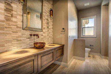 Example of a mid-sized transitional 3/4 porcelain tile and beige floor bathroom design in Other with recessed-panel cabinets, medium tone wood cabinets, a two-piece toilet, gray walls, a vessel sink and wood countertops