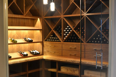 Inspiration for a mid-sized contemporary wine cellar in Seattle with ceramic floors, diamond bins and grey floor.
