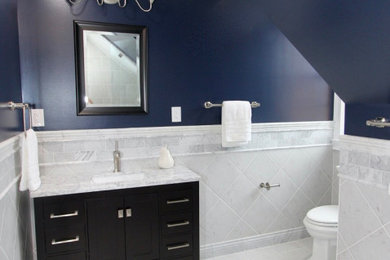 Bathroom - mid-sized traditional white tile and ceramic tile ceramic tile, white floor and single-sink bathroom idea in Baltimore with shaker cabinets, dark wood cabinets, a two-piece toilet, blue walls, a drop-in sink, marble countertops, a hinged shower door, white countertops and a freestanding vanity