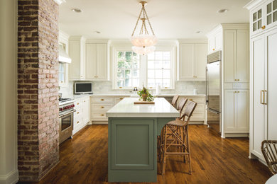 Inspiration for a timeless u-shaped medium tone wood floor eat-in kitchen remodel in Atlanta with shaker cabinets, white cabinets, white backsplash, stainless steel appliances, an island and white countertops