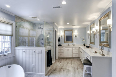 Inspiration for a large transitional master gray tile and porcelain tile porcelain tile and gray floor bathroom remodel in Philadelphia with shaker cabinets, white cabinets, a two-piece toilet, blue walls, an undermount sink, quartz countertops and a hinged shower door